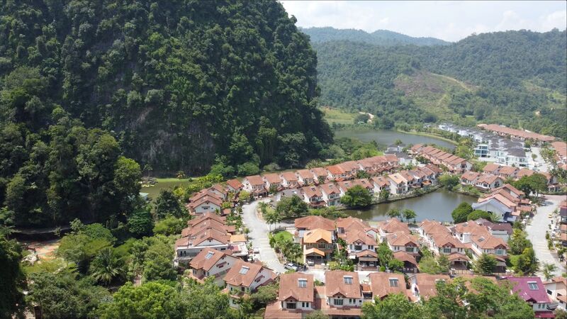 Villas nestled against limestone cliffs with lake view