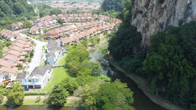 River flowing alongside the community with limestone cliff